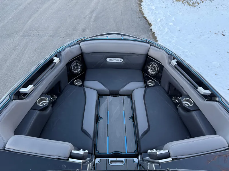 Slide: The Image of 2022 Supra SL boat interior with cushioned seating and cup holders. - 5