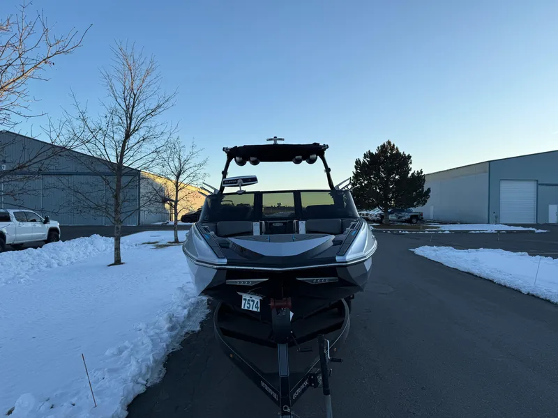 Slide: The Image of 2022 Supra SL boat on trailer in snowy industrial area. - 6