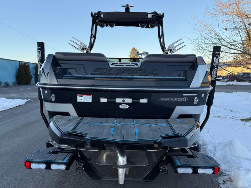 Slide: The Image of 2022 Supra SL boat rear view with snow and clear sky background. - 7