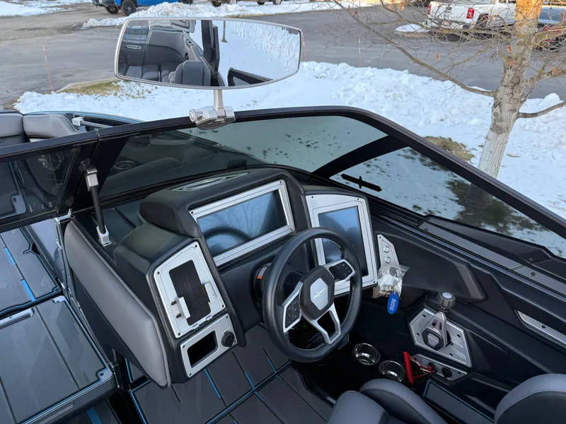 Slide: The Image of 2022 Supra SL boat interior with modern dashboard and steering wheel, parked in snowy setting. - 9