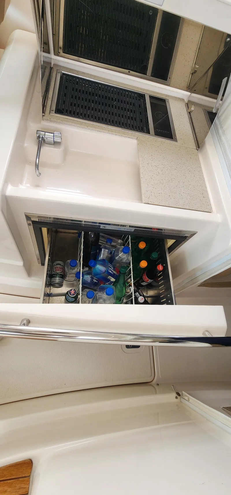 Slide: The Image of 2012 Tiara Yachts 3100 Coronet beverage storage with assorted drinks. - 10