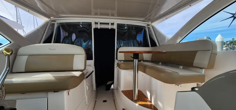 Slide: The Image of Interior of 2012 Tiara Yachts 3100 Coronet with beige seating and wooden table. - 12