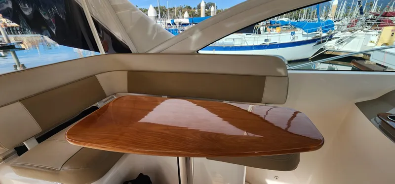 Slide: The Image of Interior of 2012 Tiara Yachts 3100 Coronet with wooden table and seating. - 13