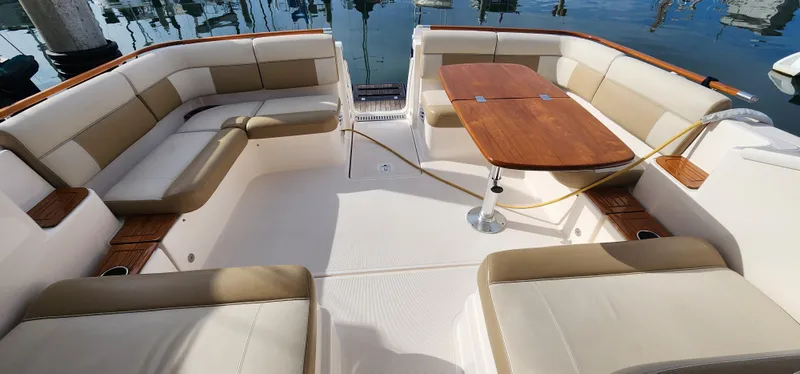 Slide: The Image of Luxurious 2012 Tiara Yachts 3100 Coronet with spacious seating and elegant wooden table. - 14