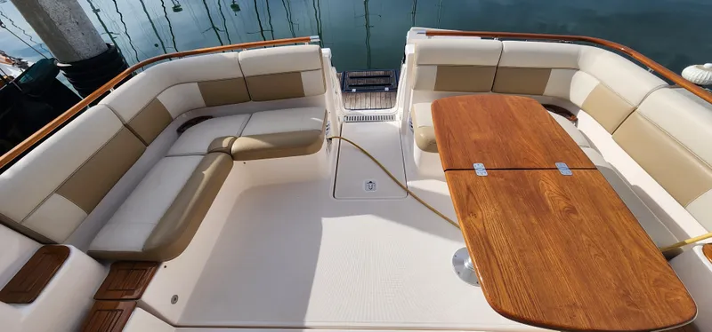 Slide: The Image of Luxurious seating area on a 2012 Tiara Yachts 3100 Coronet with wooden table. - 16