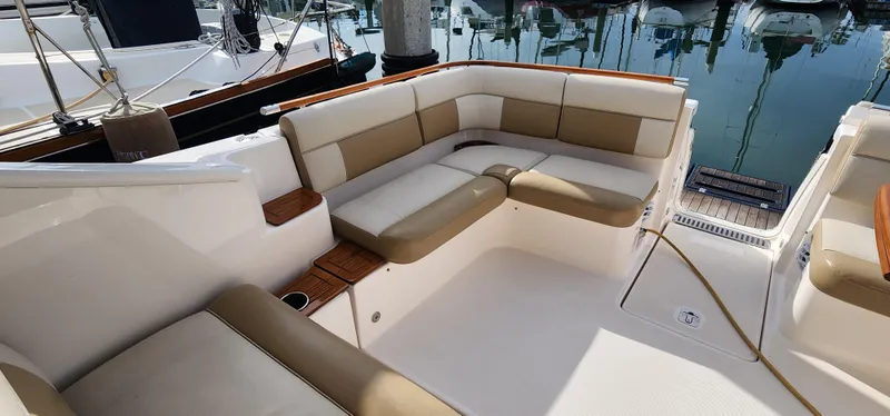 Slide: The Image of 2012 Tiara Yachts 3100 Coronet with spacious seating at marina. - 18
