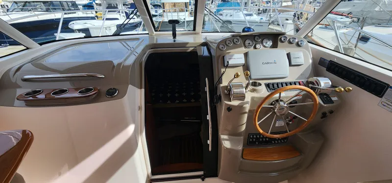 Slide: The Image of 2012 Tiara Yachts 3100 Coronet helm with steering wheel and control panel. - 2