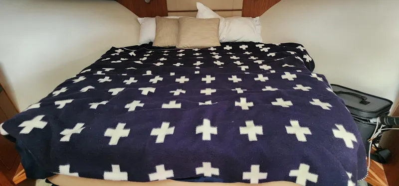 Slide: The Image of Cozy bed with cross-patterned blanket in 2012 Tiara Yachts 3100 Coronet cabin. - 26