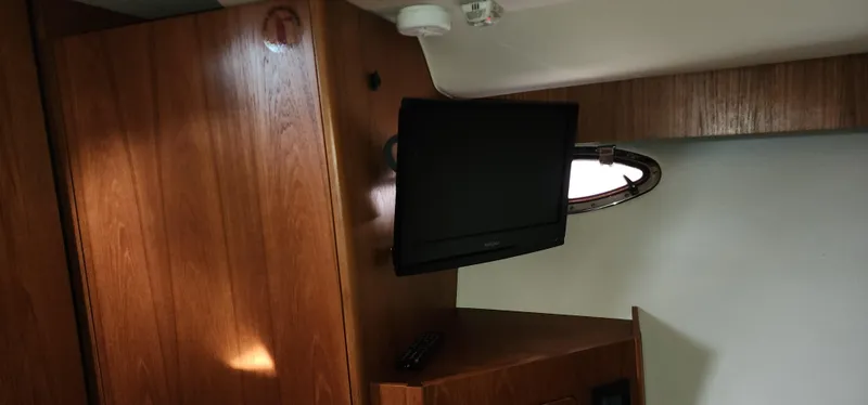 Slide: The Image of Interior of 2012 Tiara Yachts 3100 Coronet with TV and wooden cabinetry. - 28