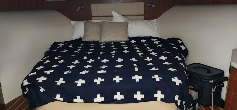 Slide: The Image of Cozy cabin interior of 2012 Tiara Yachts 3100 Coronet with patterned bedding. - 29