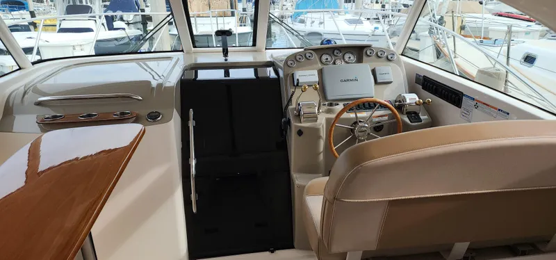 Slide: The Image of 2012 Tiara Yachts 3100 Coronet helm with modern controls and luxurious seating. - 5