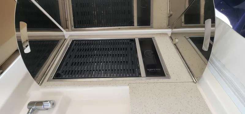 Slide: The Image of 2012 Tiara Yachts 3100 Coronet kitchen area with stove and sink. - 8