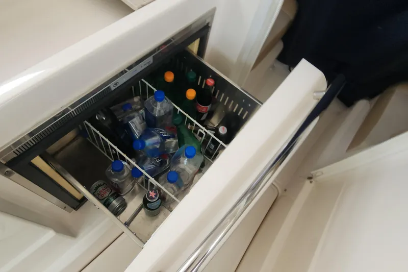 Slide: The Image of Mini fridge stocked with drinks on a 2012 Tiara Yachts 3100 Coronet. - 9