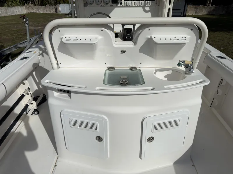 Slide: The Image of 2007 Everglades 290 CC boat console with sink and storage compartments. - 15