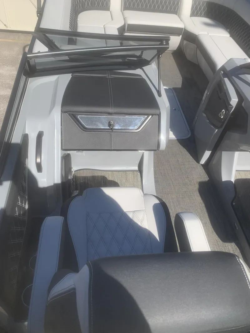 Slide: The Image of 2025 Godfrey San Pan 2700 DFLW boat interior with modern seating and dashboard. - 10