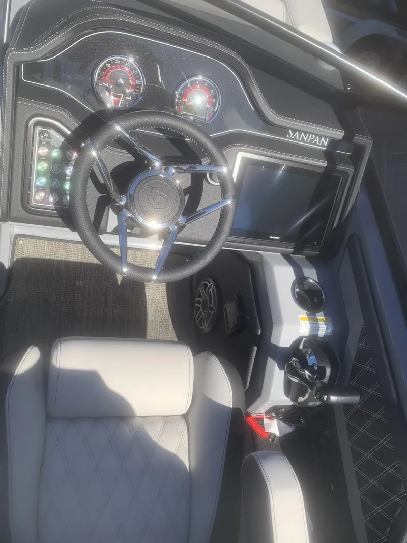 Slide: The Image of Interior dashboard of 2025 Godfrey San Pan 2700 DFLW boat with steering wheel and controls. - 13