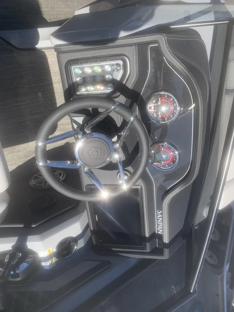 Slide: The Image of Steering console of 2025 Godfrey San Pan 2700 DFLW boat with modern controls. - 14
