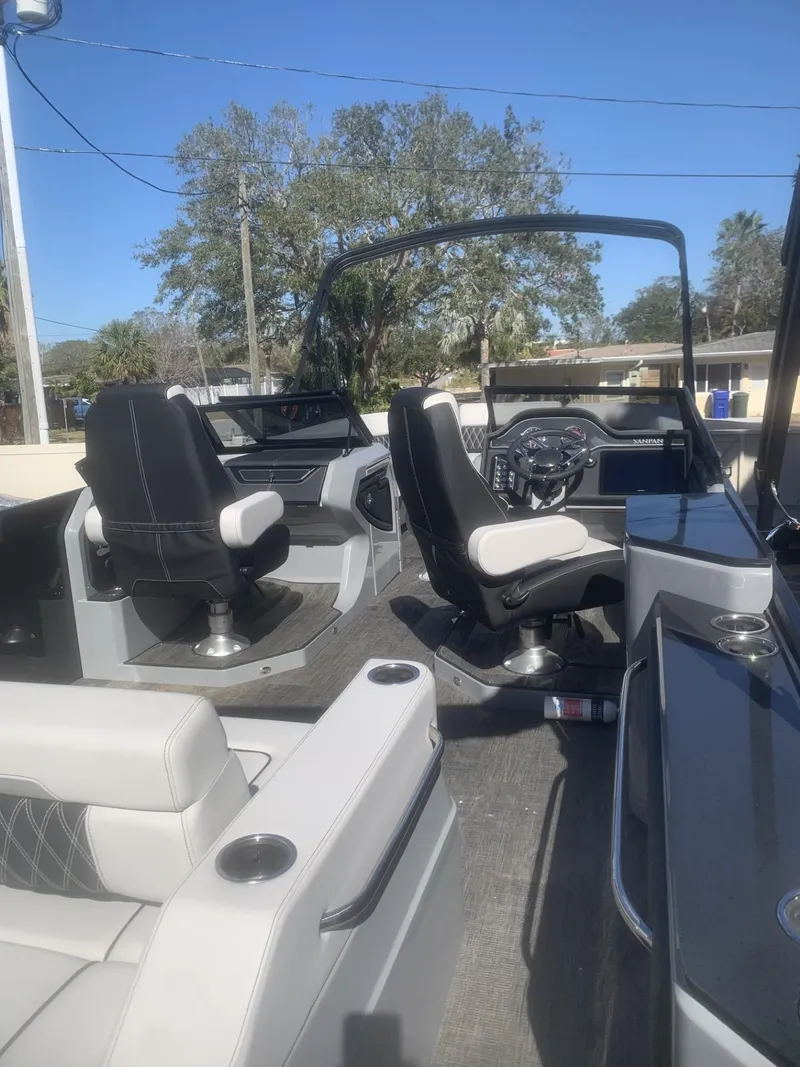 Slide: The Image of 2025 Godfrey San Pan 2700 DFLW boat interior with modern seating and steering wheel. - 15