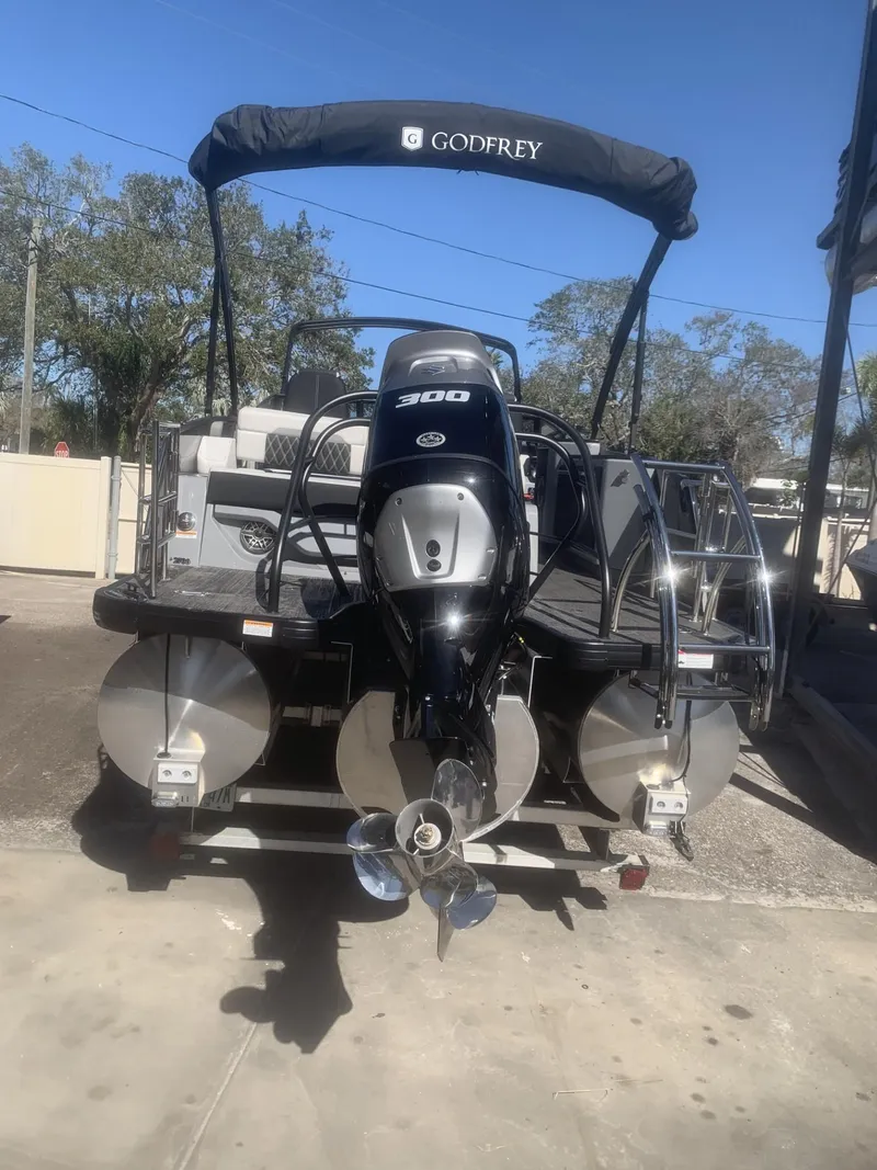 Slide: The Image of 2025 Godfrey San Pan 2700 DFLW pontoon boat with powerful outboard motor. - 2