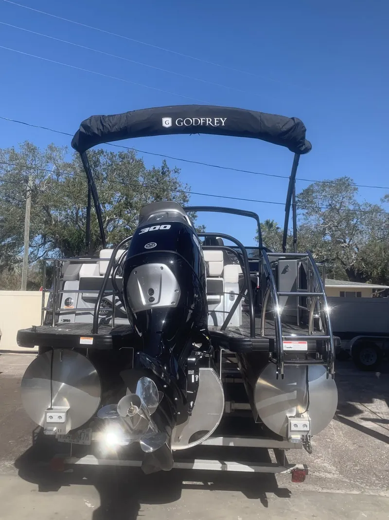 Slide: The Image of 2025 Godfrey San Pan 2700 DFLW pontoon boat with powerful outboard motor. - 4