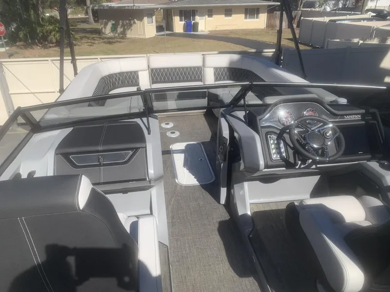 Slide: The Image of 2025 Godfrey San Pan 2700 DFLW boat interior with modern dashboard and seating. - 5