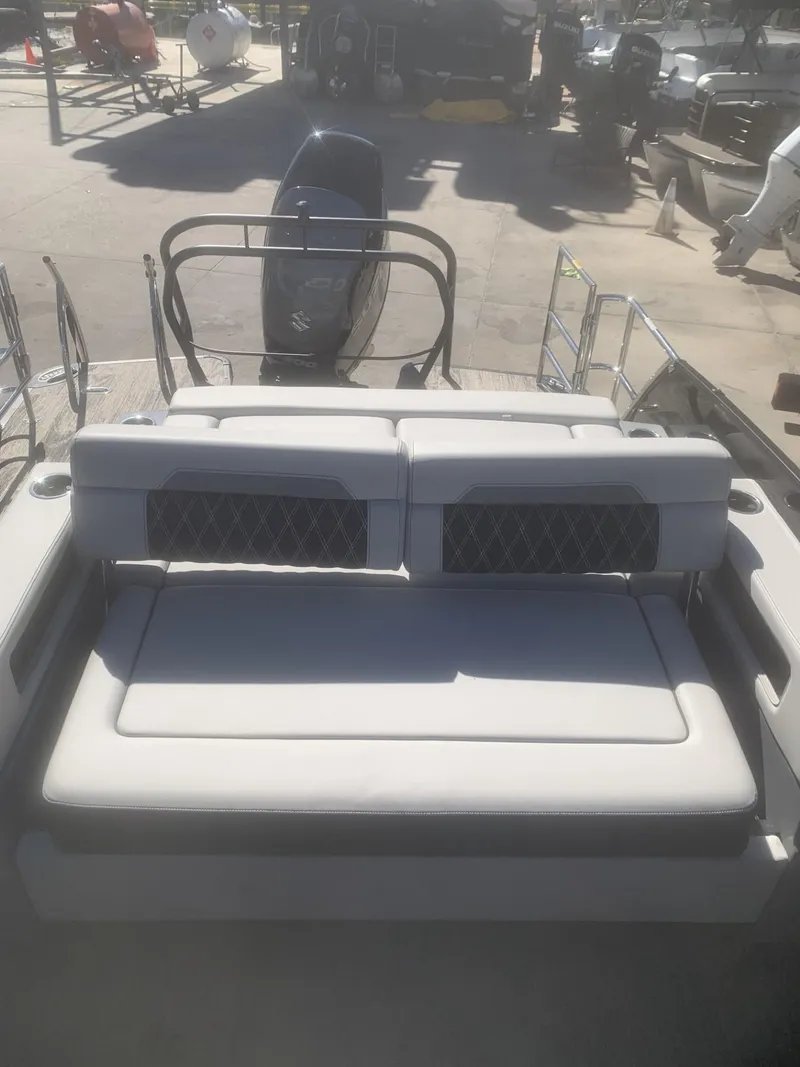 Slide: The Image of 2025 Godfrey San Pan 2700 DFLW boat with cushioned seating and sleek design. - 6
