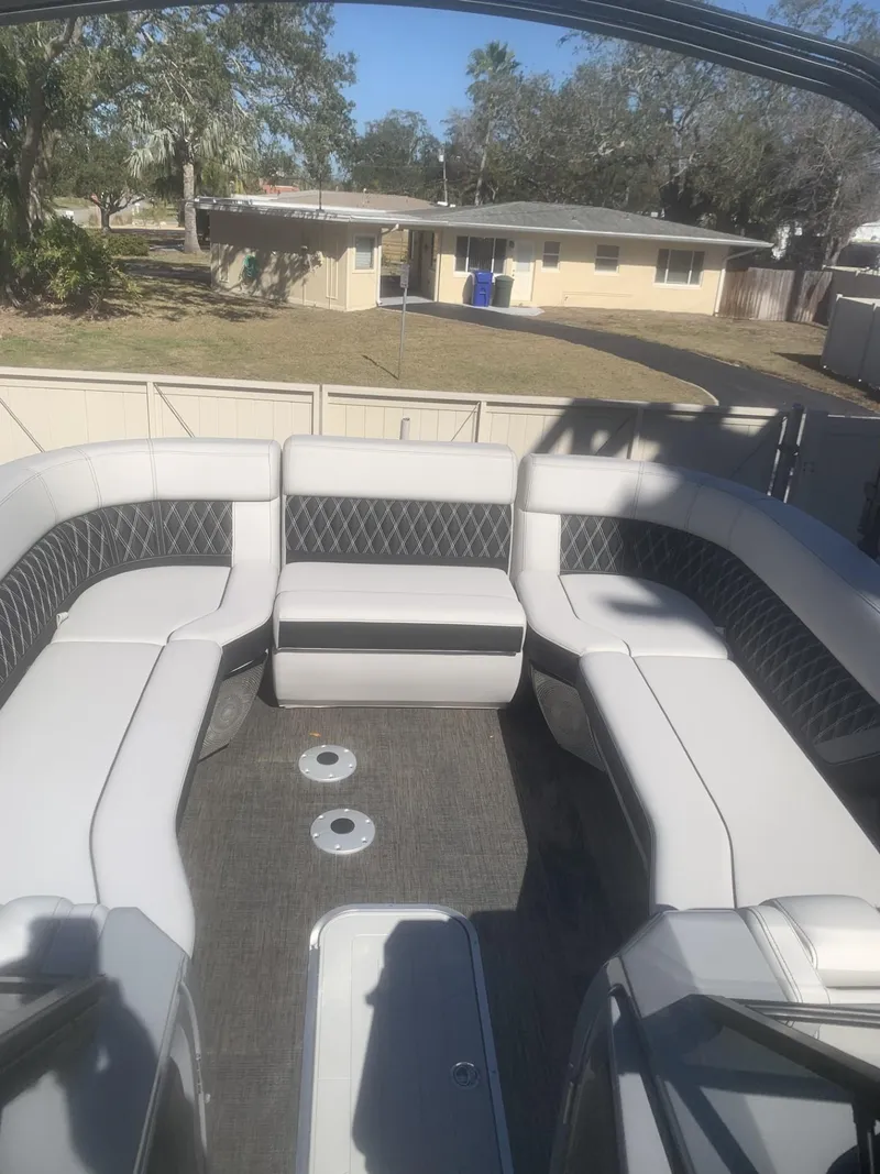 Slide: The Image of 2025 Godfrey San Pan 2700 DFLW pontoon boat with spacious seating and modern design. - 7