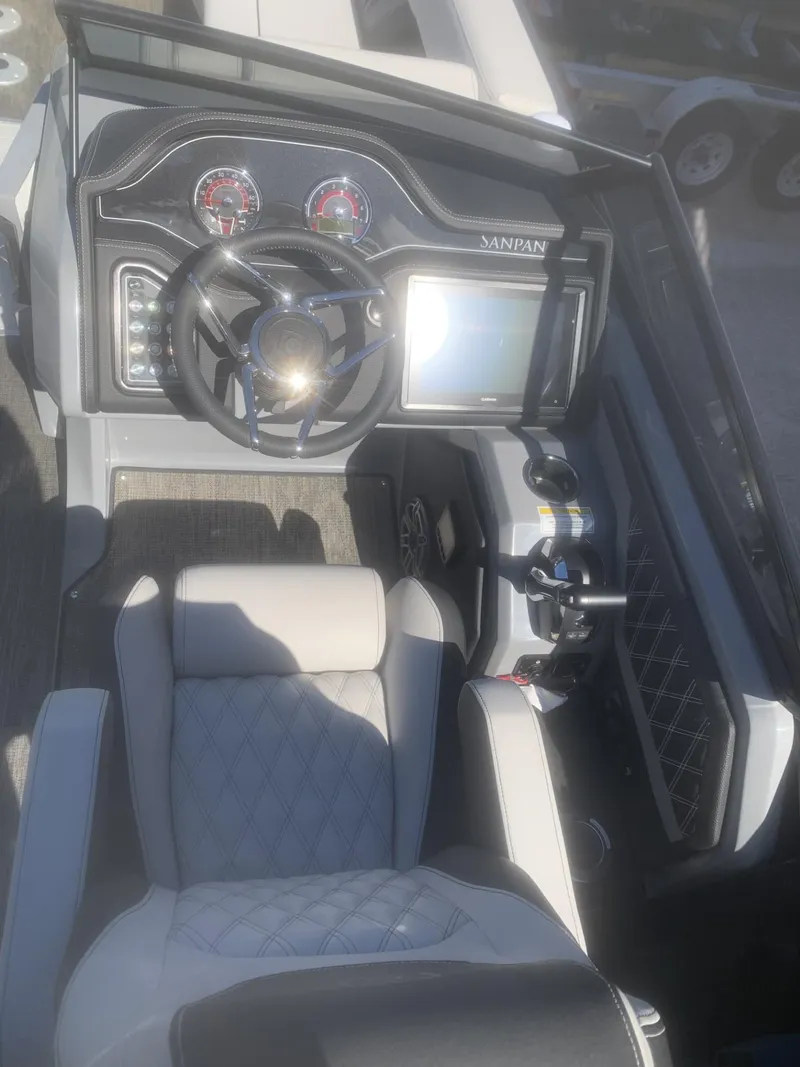 Slide: The Image of 2025 Godfrey San Pan 2700 DFLW boat dashboard with steering wheel and control panel. - 9