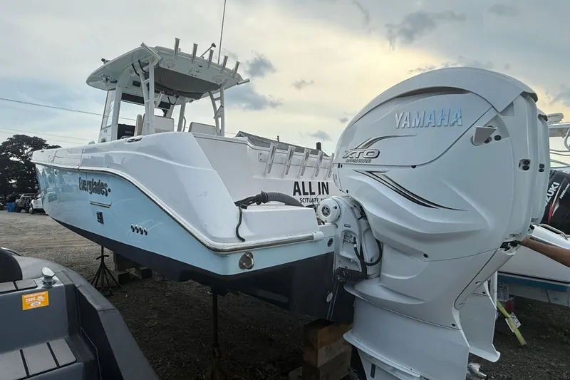 The Image of 2014 Everglades 325 Center Console boat on calm water, with twin Yamaha engines. - 0