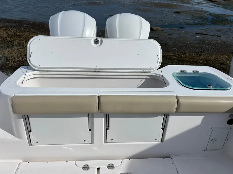 Slide: The Image of 2014 Everglades 325 Center Console boat interior on calm water under cloudy sky. - 10