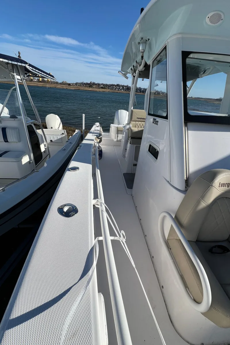 Slide: The Image of 2014 Everglades 325 Center Console boat on calm water under cloudy skies. - 17