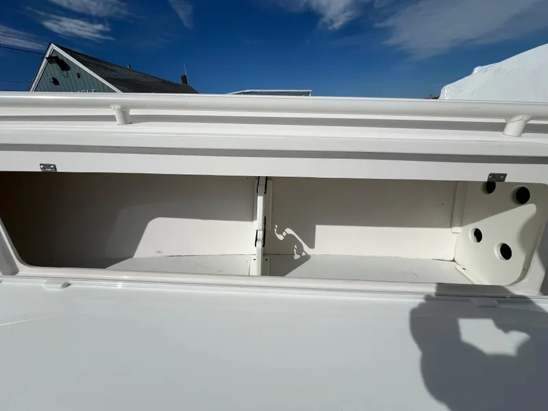 Slide: The Image of 2014 Everglades 325 Center Console boat on calm water, featuring twin engines. - 9