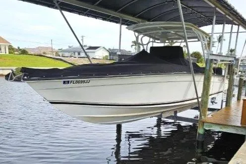 Slide: The Image of 1993 Marlin Yachts Cuddy SF boat docked under a canopy. - 0