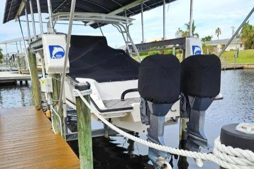 Slide: The Image of 1993 Marlin Yachts Cuddy SF docked with covered engines, side view. - 1