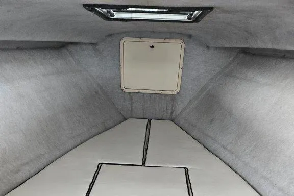 Slide: The Image of 1993 Marlin Yachts Cuddy SF interior cabin with gray upholstery and hatch. - 10