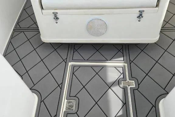 Slide: The Image of 1993 Marlin Yachts Cuddy SF interior with diamond-patterned flooring and storage compartment. - 19