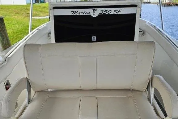 Slide: The Image of 1993 Marlin Yachts Cuddy SF boat interior with cushioned seating and "350 SF" branding. - 23