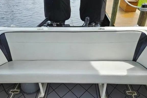Slide: The Image of 1993 Marlin Yachts Cuddy SF boat interior with cushioned seating and outboard motors. - 24