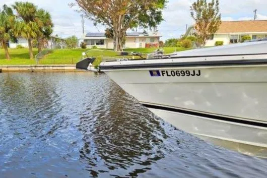Slide: The Image of 1993 Marlin Yachts Cuddy SF boat docked on a calm waterway. - 3