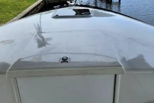 Slide: The Image of 1993 Marlin Yachts Cuddy SF boat deck, docked by the water. - 4