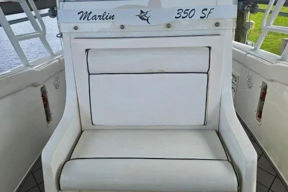 Slide: The Image of 1993 Marlin Yachts Cuddy SF interior with white cushioned seating. - 5