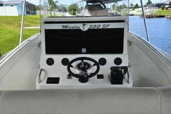 Slide: The Image of 1993 Marlin Yachts Cuddy SF boat dashboard with steering wheel and controls. - 6