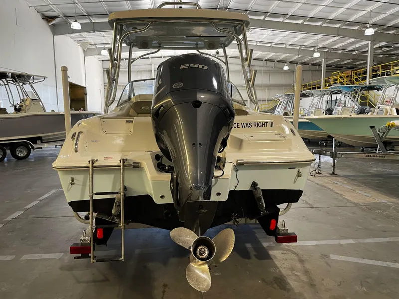 Slide: The Image of 2023 Key West 239 DFS boat in a warehouse, rear view with outboard motor. - 11