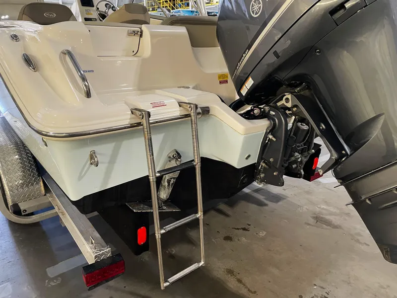Slide: The Image of 2023 Key West 239 DFS boat with ladder and outboard motor in a garage. - 12