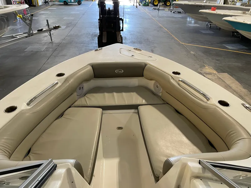 Slide: The Image of 2023 Key West 239 DFS boat interior with beige seating in a showroom. - 18