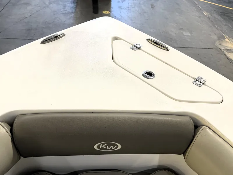Slide: The Image of 2023 Key West 239 DFS boat interior, featuring bow seating and storage compartment. - 19