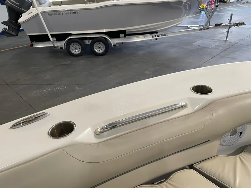 Slide: The Image of 2023 Key West 239 DFS boat interior with cup holders and trailer in background. - 20