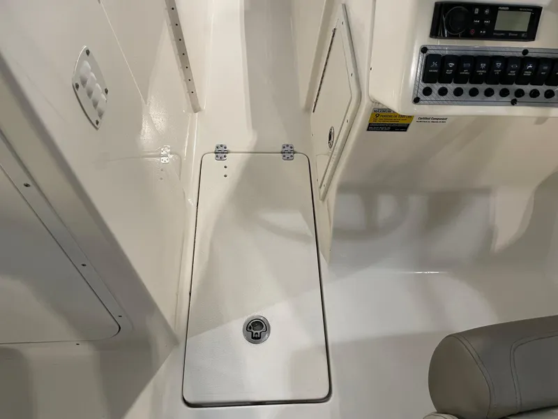 Slide: The Image of 2023 Key West 239 DFS boat interior with control panel and storage compartment. - 22