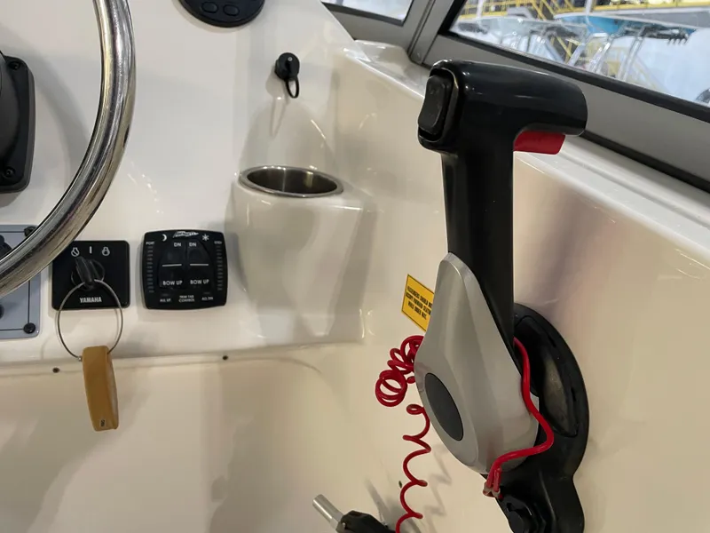 Slide: The Image of 2023 Key West 239 DFS boat cockpit with steering wheel and control panel. - 26