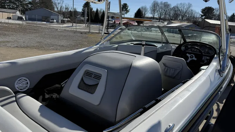 Slide: The Image of 2007 Centurion T5 boat interior with steering wheel and seating, parked outdoors. - 10